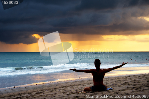 Image of Man exercising yoga. Bali,  beach