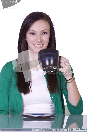 Image of  Teenager Drinking Coffee While Working on the Computer