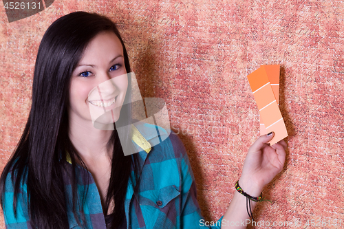 Image of Girl Choosing a Color for the Walls