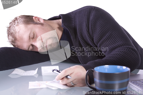 Image of Young Casual Businessman Sleeping at his Desk