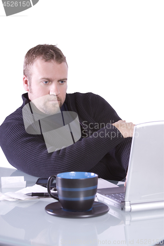 Image of Young Casual Businessman Working at his Desk