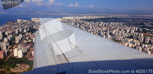 Image of Plane flying above city