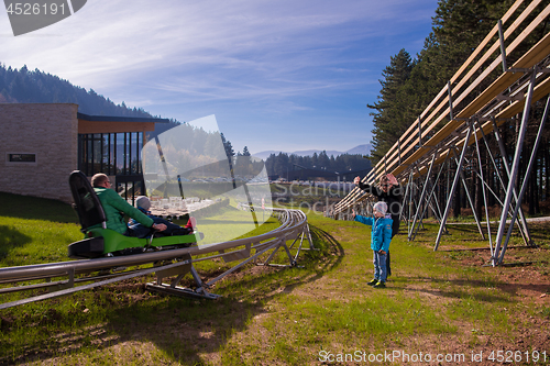 Image of Happy family enjoying alpine coaster