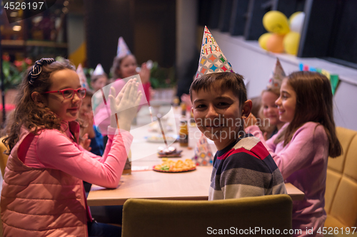 Image of The young boy joyfully celebrating his birthday