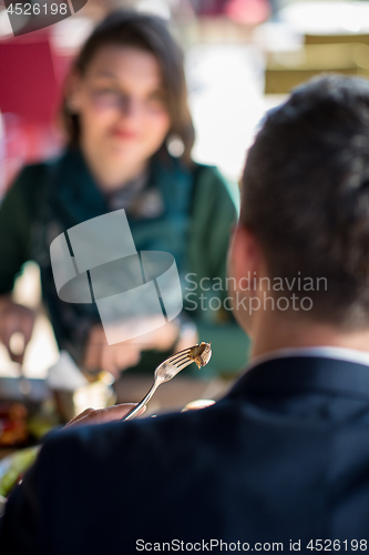 Image of youn couple enjoying lunch at restaurant