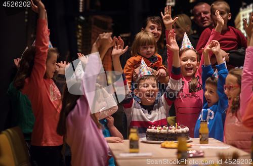 Image of happy young boy having birthday party