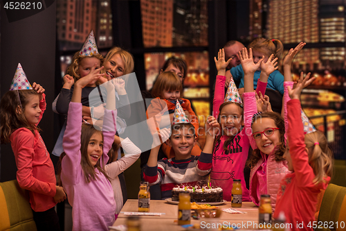 Image of happy young boy having birthday party