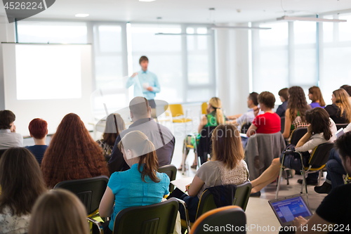 Image of Speaker giving presentation on business conference meeting.