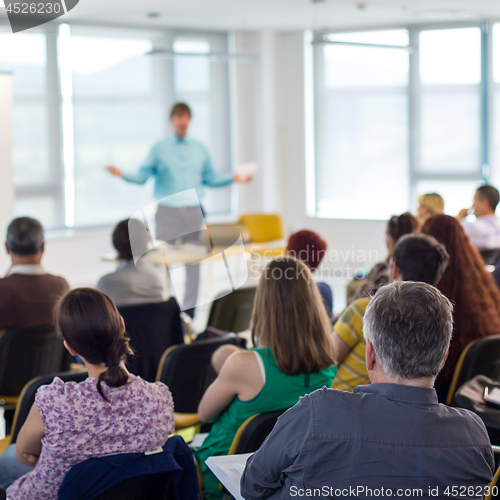 Image of Speaker giving presentation on business conference.