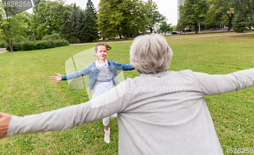 Image of grandmother and granddaughter playing at park