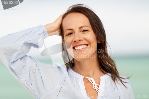 Image of happy smiling woman on summer beach