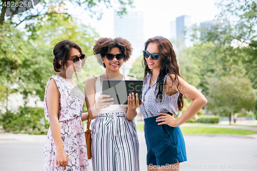 Image of women with tablet computer on street in summer