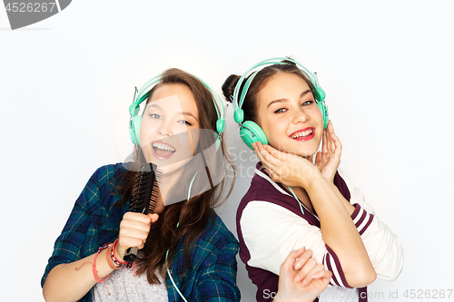 Image of teenage girls in earphones listening to music