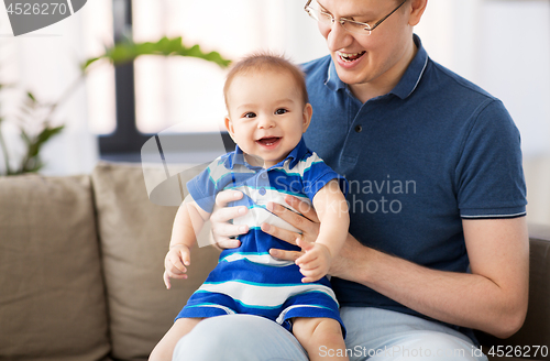 Image of happy father with baby son at home