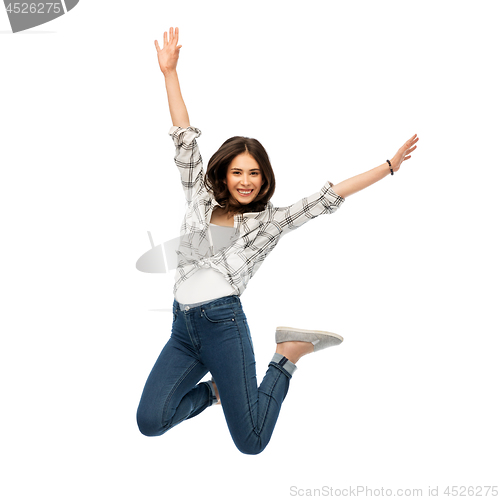 Image of happy young woman or teenage girl jumping