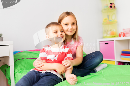 Image of happy little kids hugging at home