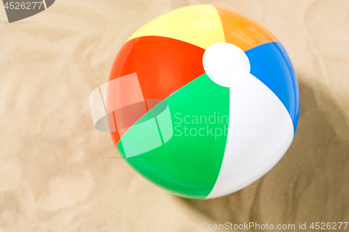 Image of close up of inflatable beach ball on sand