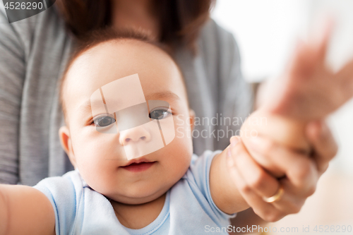 Image of close up of asian baby boy with mother