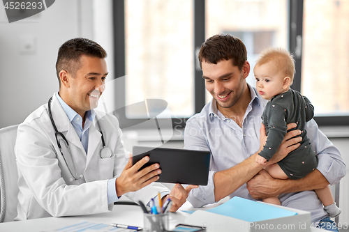 Image of father with baby and doctor with tablet at clinic