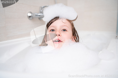 Image of little girl in bath playing with foam