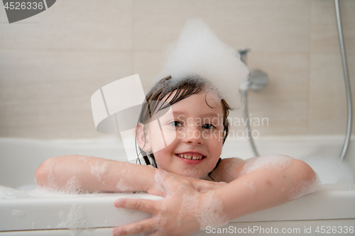 Image of little girl in bath playing with foam