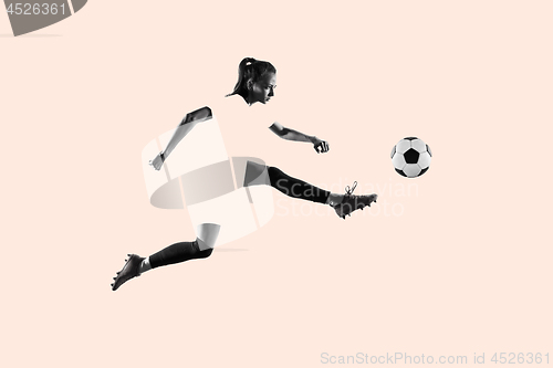 Image of Female soccer player kicking ball, creative collage