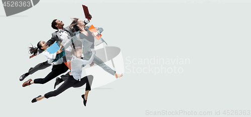 Image of Office workers jumping isolated on studio background