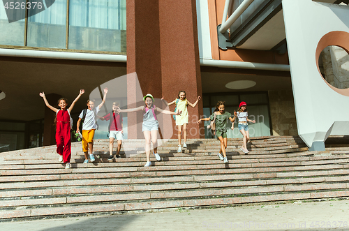 Image of Happy kids playing at city\'s street in sunny summer\'s day