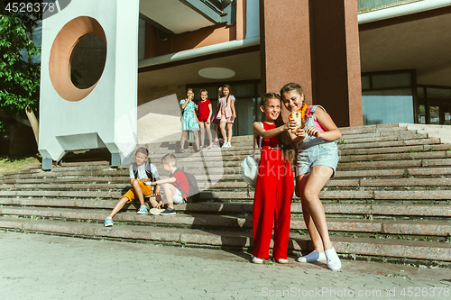 Image of Happy kids playing at city\'s street in sunny summer\'s day