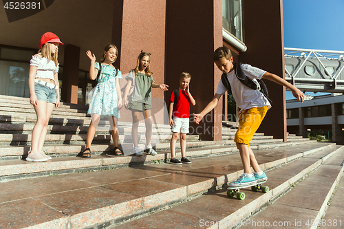 Image of Happy kids playing at city\'s street in sunny summer\'s day