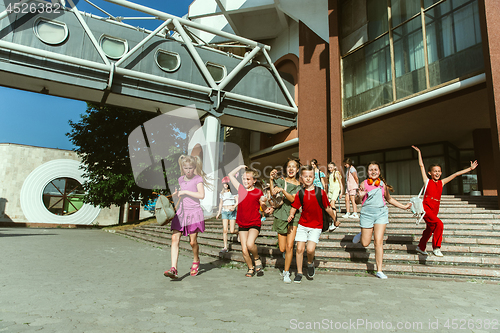 Image of Happy kids playing at city\'s street in sunny summer\'s day