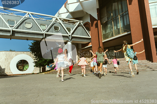 Image of Happy kids playing at city\'s street in sunny summer\'s day