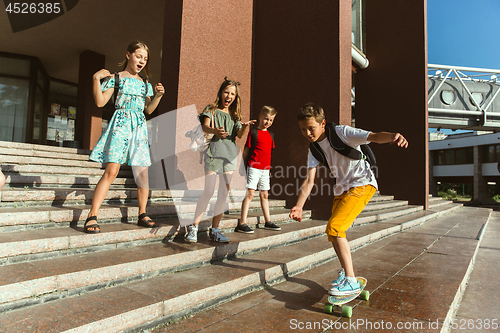 Image of Happy kids playing at city\'s street in sunny summer\'s day