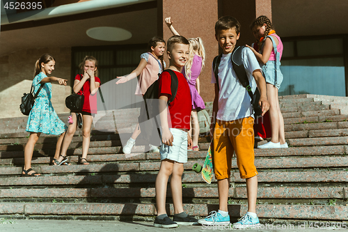 Image of Happy kids playing at city\'s street in sunny summer\'s day