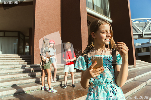 Image of Happy kids playing at city\'s street in sunny summer\'s day