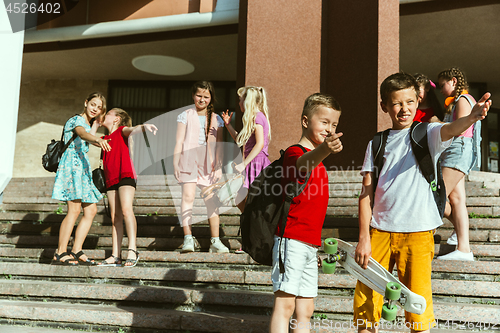 Image of Happy kids playing at city\'s street in sunny summer\'s day