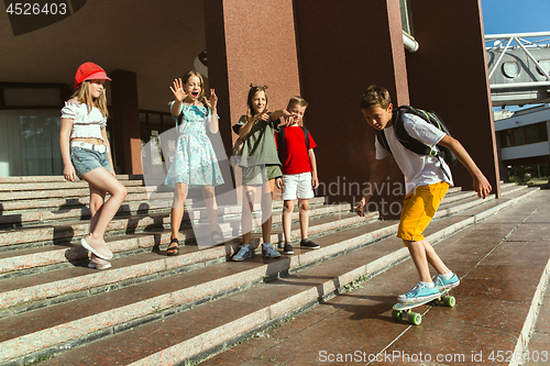 Image of Happy kids playing at city\'s street in sunny summer\'s day