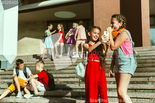 Image of Happy kids playing at city\'s street in sunny summer\'s day