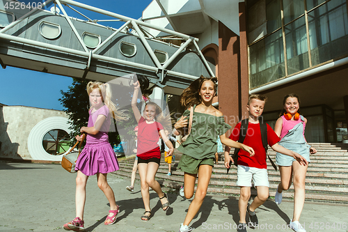 Image of Happy kids playing at city\'s street in sunny summer\'s day