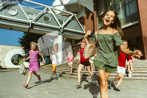 Image of Happy kids playing at city\'s street in sunny summer\'s day