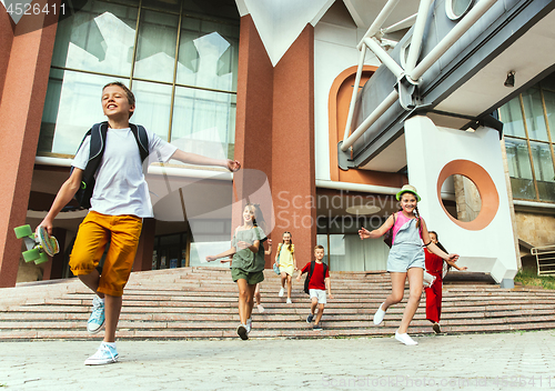 Image of Happy kids playing at city\'s street in sunny summer\'s day