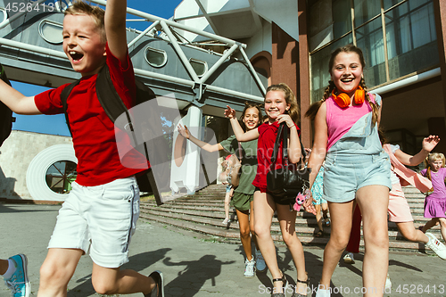 Image of Happy kids playing at city\'s street in sunny summer\'s day