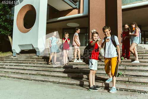 Image of Happy kids playing at city\'s street in sunny summer\'s day