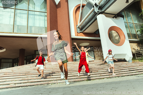 Image of Happy kids playing at city\'s street in sunny summer\'s day