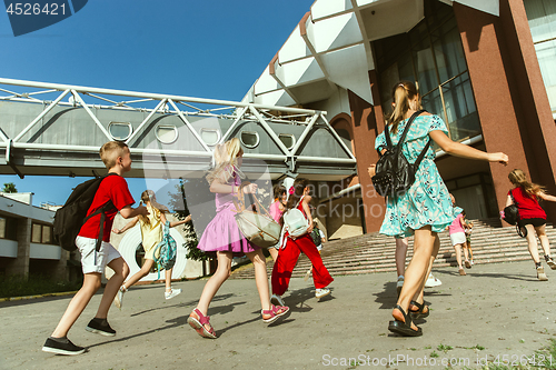 Image of Happy kids playing at city\'s street in sunny summer\'s day