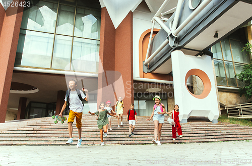 Image of Happy kids playing at city\'s street in sunny summer\'s day