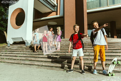 Image of Happy kids playing at city\'s street in sunny summer\'s day