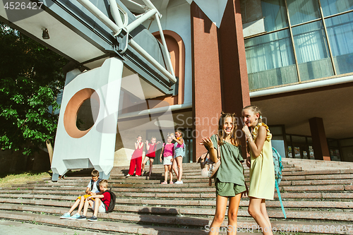 Image of Happy kids playing at city\'s street in sunny summer\'s day