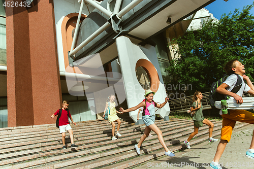 Image of Happy kids playing at city\'s street in sunny summer\'s day