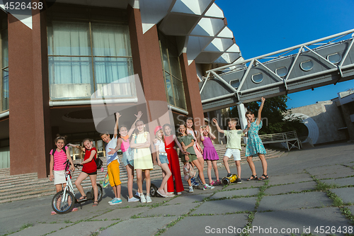 Image of Happy kids playing at city\'s street in sunny summer\'s day